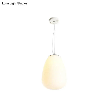 A sleek nordica pendant light with frosted opal glass shade and polished chrome, ideal for office and kitchen island lighting