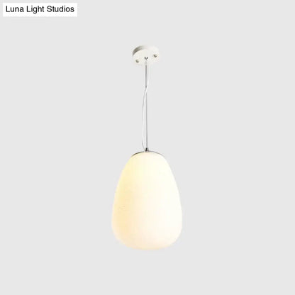 A sleek nordica pendant light with teardrop opal glass shade and polished chrome hardware ideal for office and kitchen island