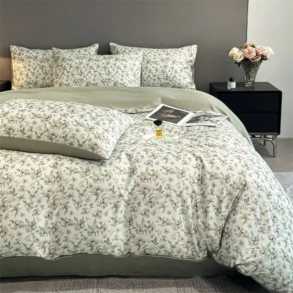 A soft cream-colored satin silk duvet cover set with a delicate gray floral pattern from DecorBites summer collection
