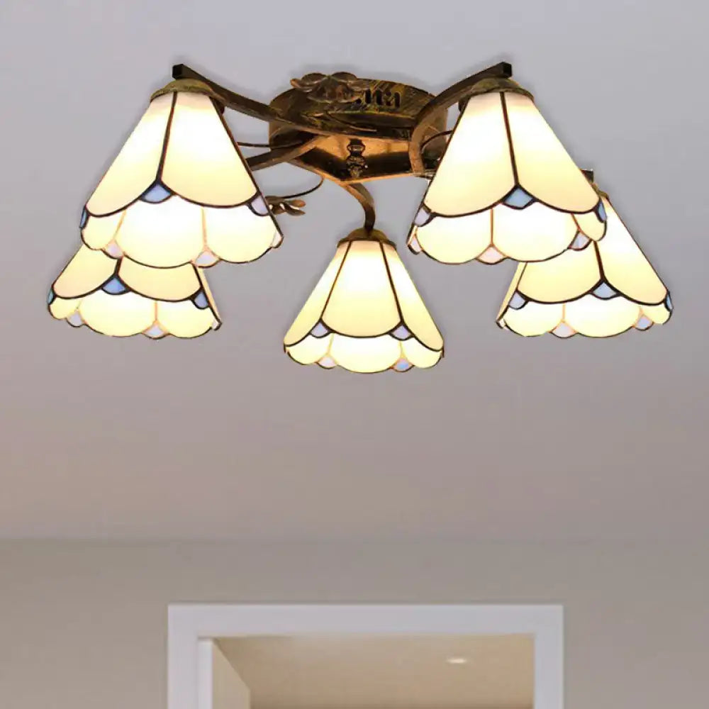 Vintage-style tiffany stained glass ceiling light with five cream and blue floral shades in antique bronze finish