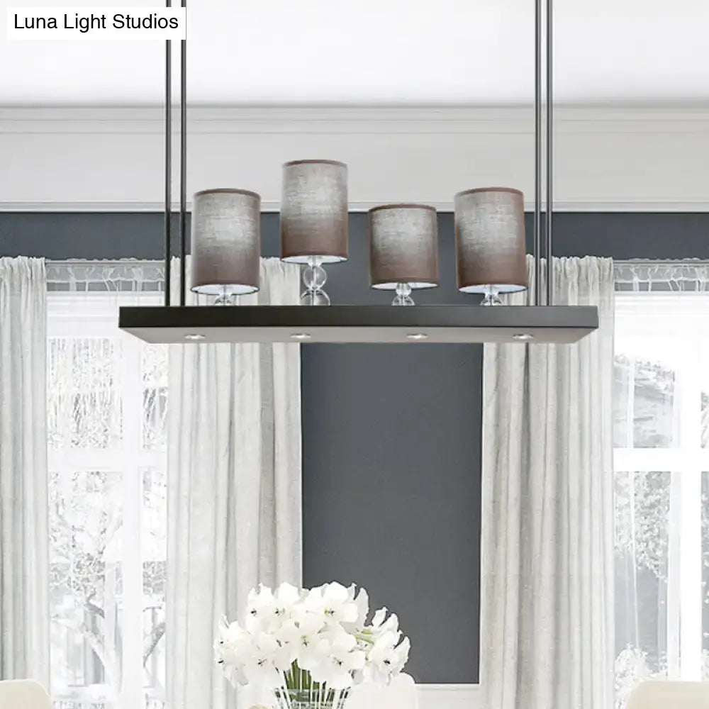 Modern rectangular decorbites island light fixture with four brown fabric shades and black metal frame for dining room