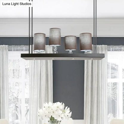 Modern rectangular decorbites island light fixture with four brown fabric shades and black metal frame for dining room