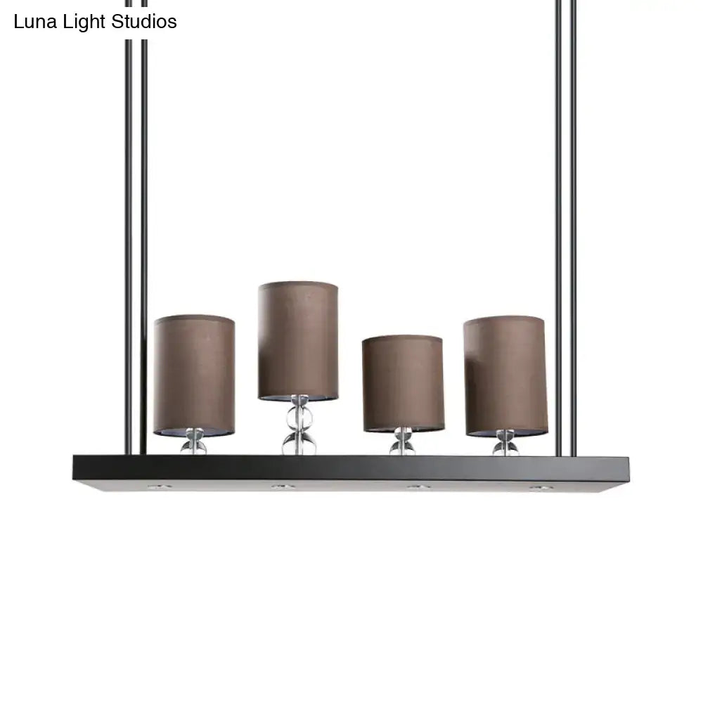 Modern rectangular pendant island light fixture with four taupe fabric shades and chrome accents linear shelf