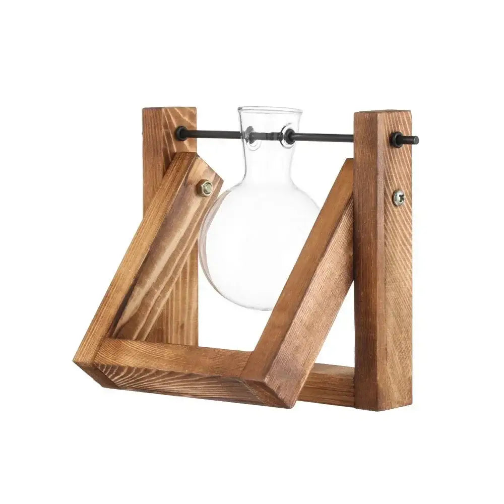 Clear glass flask mounted in a rustic wooden frame with black metal hardware for avocado seed starter use