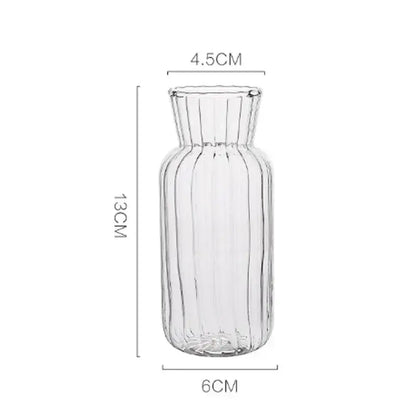 Clear glass transparent nordic vase with vertical ribbed texture and flared neck for plants and flowers by DecorBites