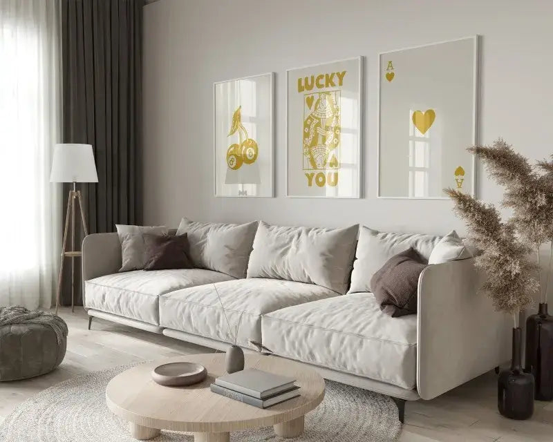 Beige upholstered sectional sofa with dark gray throw pillows and modern design paired with DecorBites wall art posters