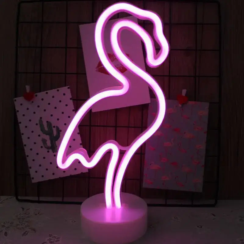 A glowing pink led neon flamingo sign lamp with a sleek curved design and white circular base for home decoration