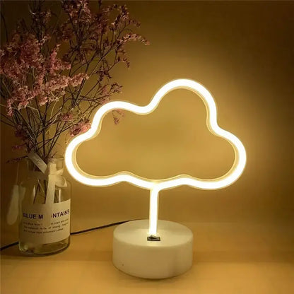 A warm glowing led neon cloud sign with a sleek white base ideal for holiday party wedding home decor