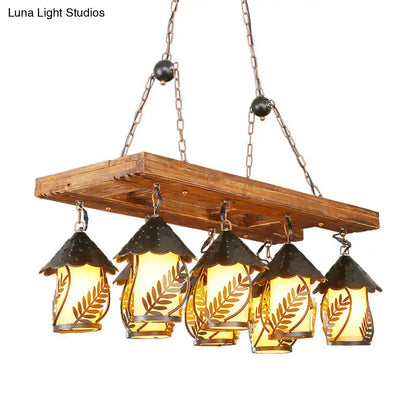 Decorbites vintage 8-light island pendant chandelier with rustic wooden plank, amber glass lanterns, and black metal roofs