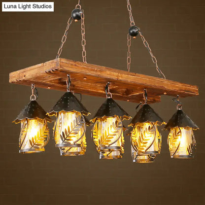 Rustic wooden beam chandelier with five black metal birdhouse shades featuring leaf etchings warm amber glass panels rectangle white fabric clear glass construction compatible with 220v-240v 110v-120v