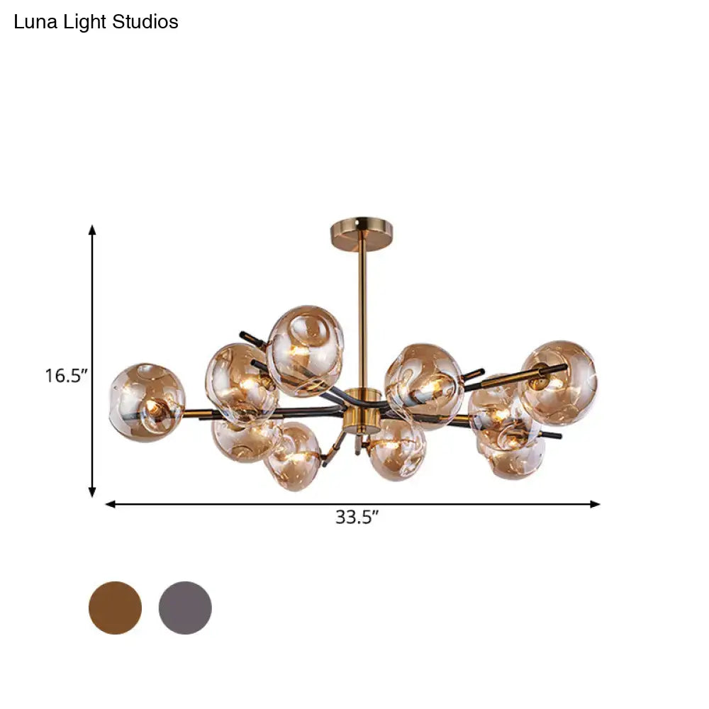 Modern brass-finished flush mount chandelier with amber glass spheres in branching design for elegant living room lighting