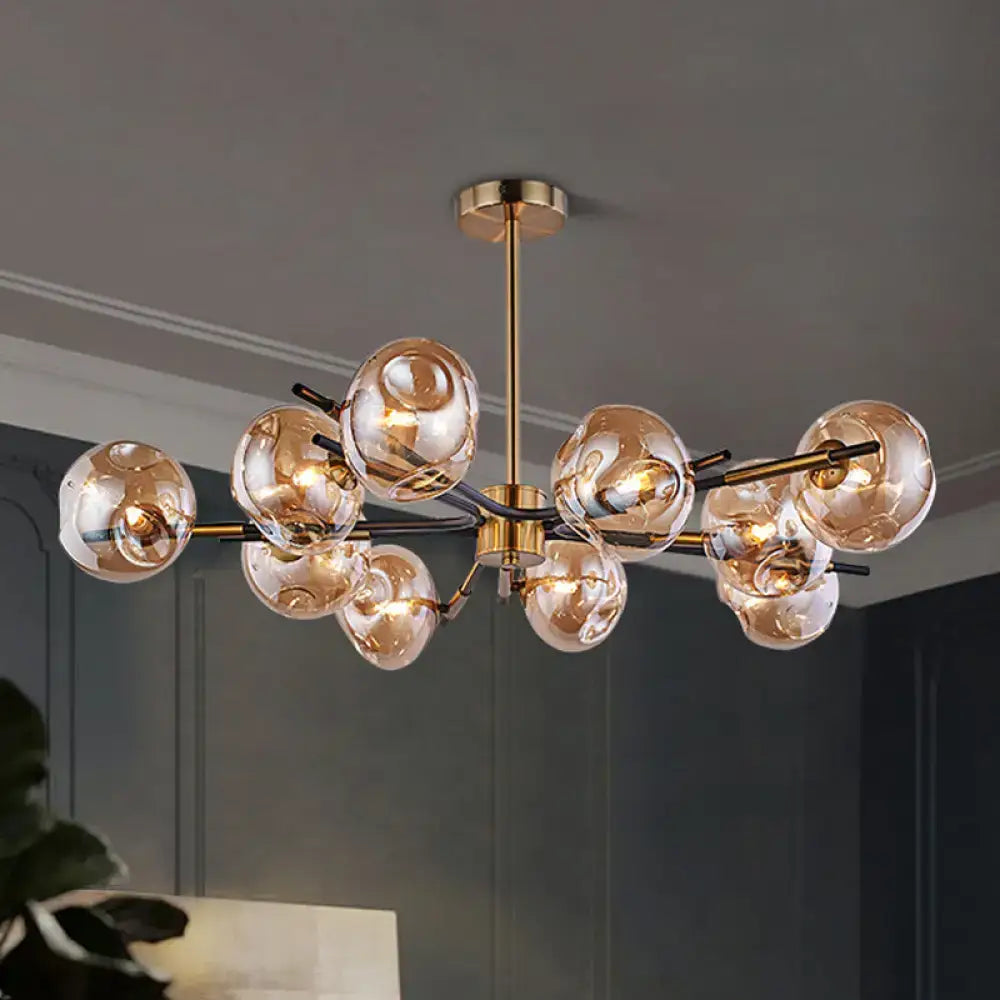 Modern brass-finished flush mount chandelier with amber-tinted glass globes for elegant living room lighting