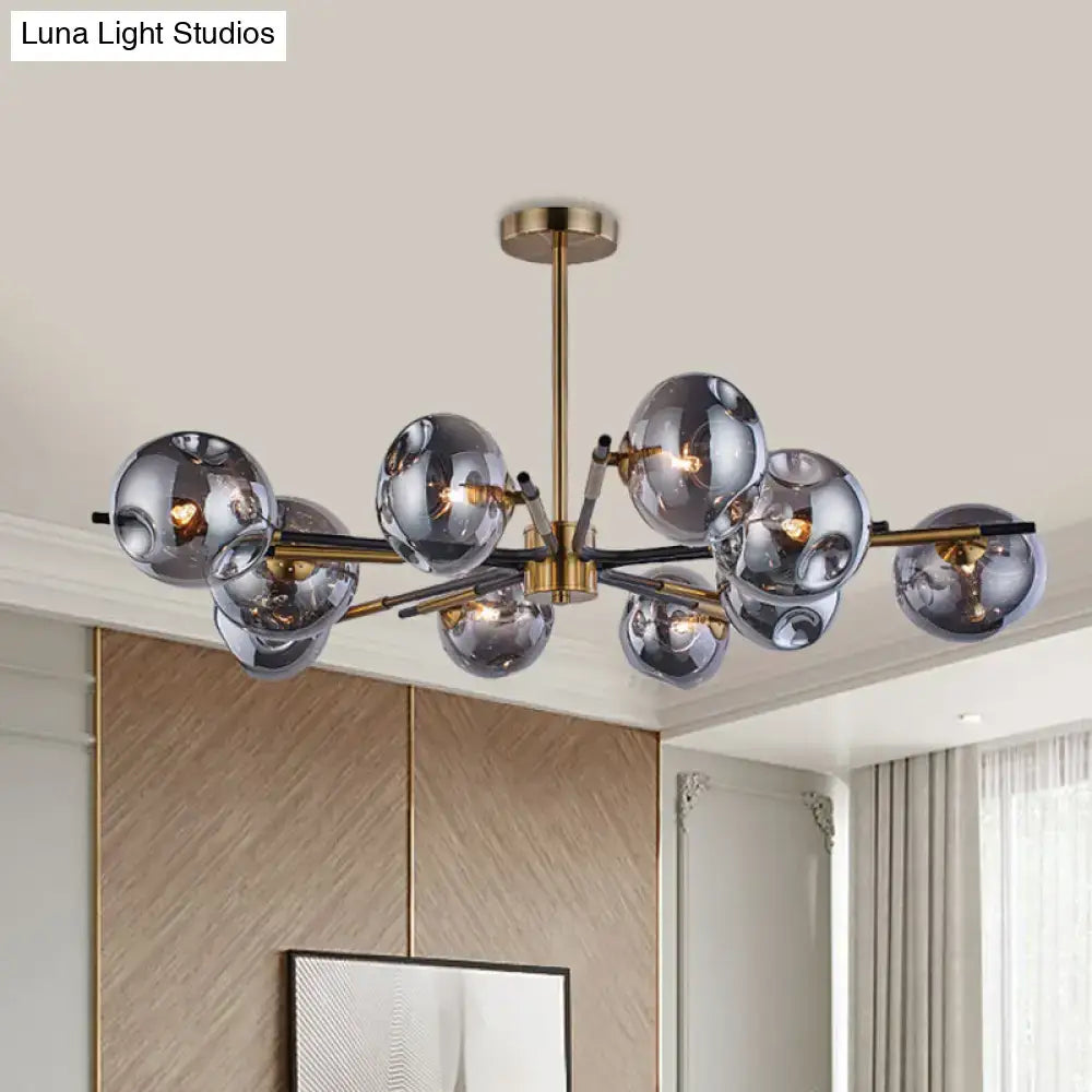 Modern brass-finished flush mount chandelier with smoked amber and grey glass spheres for living room elegance