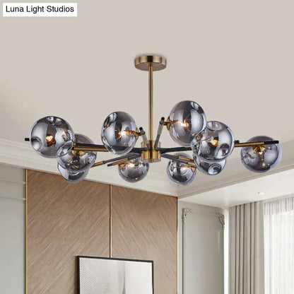 Modern brass-finished flush mount chandelier with smoked amber and grey glass spheres for living room elegance