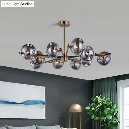 Modern brass-finished flush mount chandelier with frosted glass spheres for elegant living room lighting by DecorBites