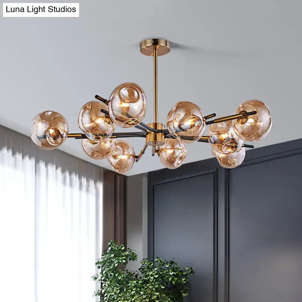 Modern brass-finished decorbites flush mount chandelier with 10 amber-tinted glass globe shades for living room