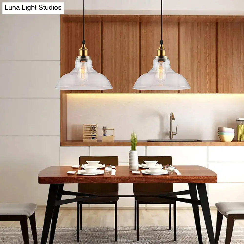 Two clear glass DecorBites™ vintage chrome pendant lights with brass accents hang above a wooden dining table