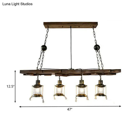 Rustic dark wood island lamp with four brass lantern-style lights and black metal chains for vintage decor
