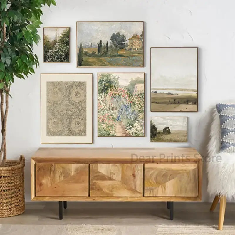 A rustic wooden console table with natural finish and geometric drawer inlays complements vintage farmhouse landscape oil painting wall art