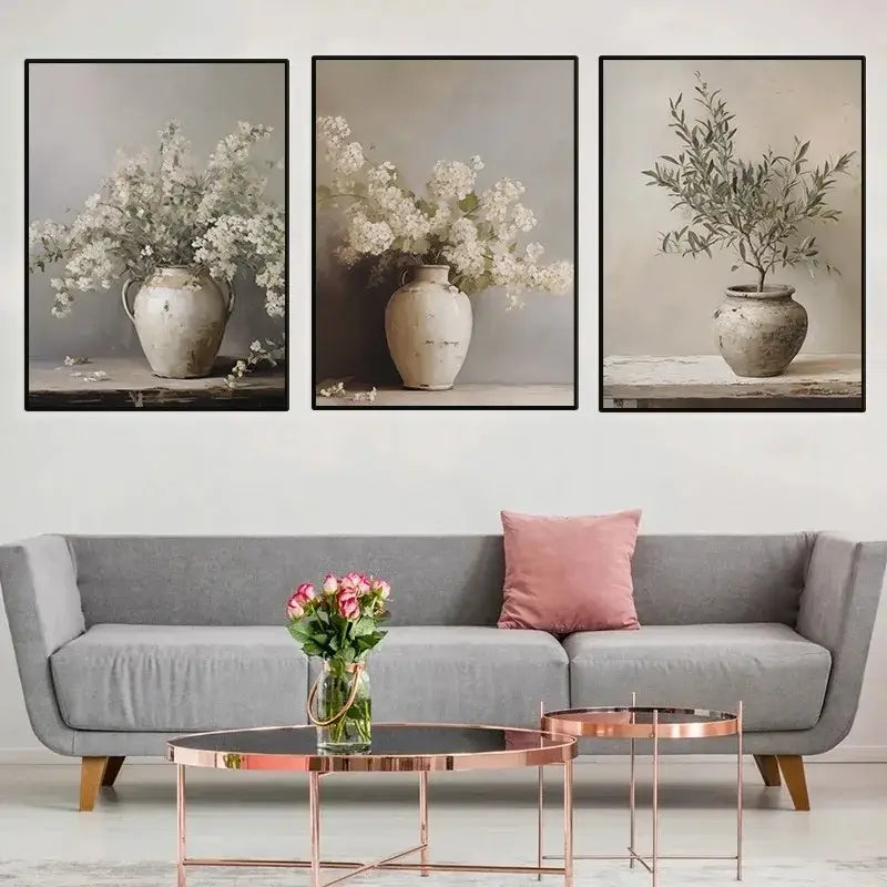 Set of three framed DecorBites™ vintage floral vase canvas wall art featuring rustic weathered ceramic vases with white and green flowers