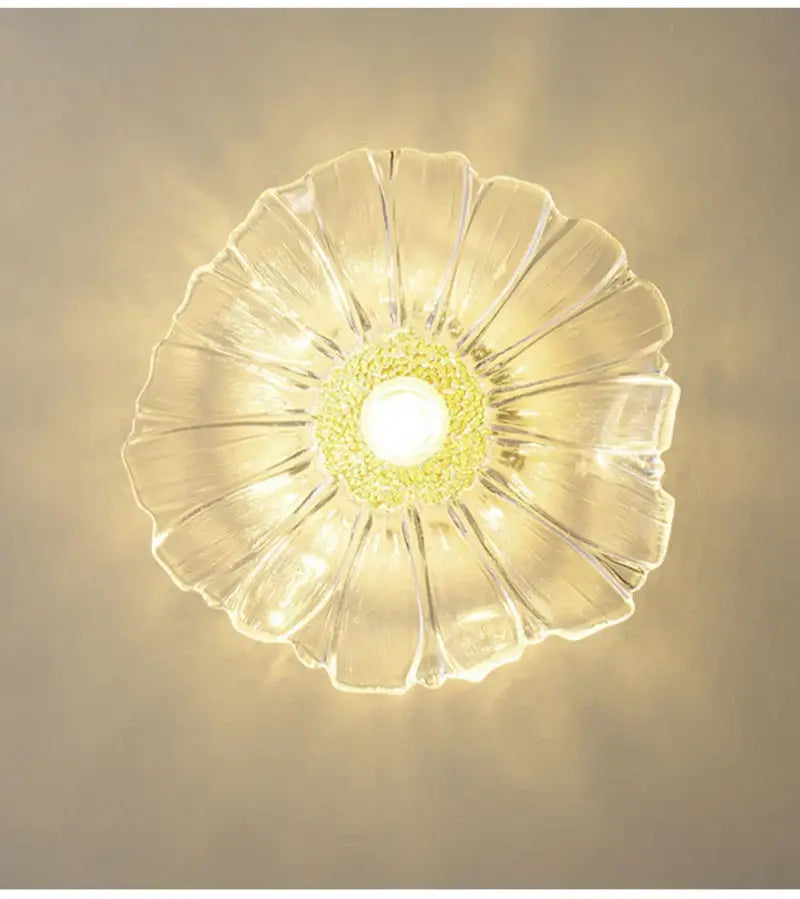 Clear glass ceiling pendant light with petal-like design and central yellow-green textured flower glass accent for home decor