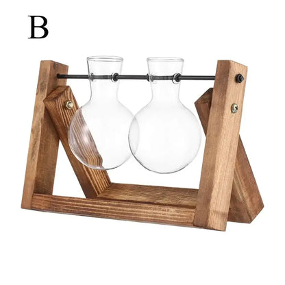 Wooden stand with black metal bar holding two clear rounded-bottom glass vases for vintage glass hydroponic plant decor