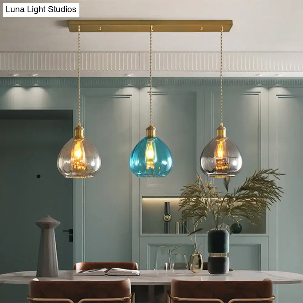 DecorBites vintage glass onion multi ceiling light pendant in brass with tan, blue, and grey glass shades hanging