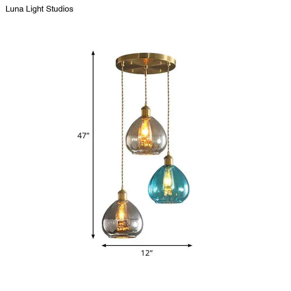 Three pendant glass onion multi ceiling lights with tan blue grey glass shades and brass chains by DecorBites vintage collection