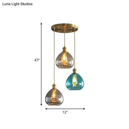 Three pendant glass onion multi ceiling lights with tan blue grey glass shades and brass chains by DecorBites vintage collection