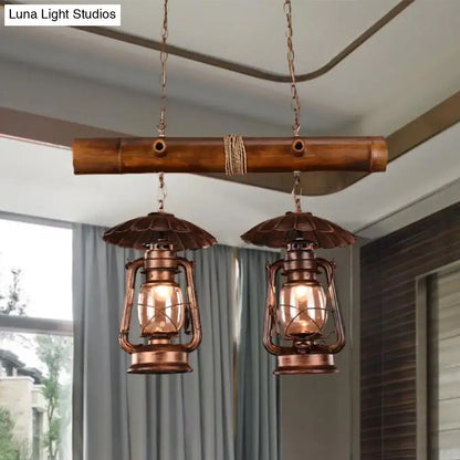 Decorbites™ vintage industrial 2-light island pendant in red brown with kerosene metallic chandelier finish above bamboo bar