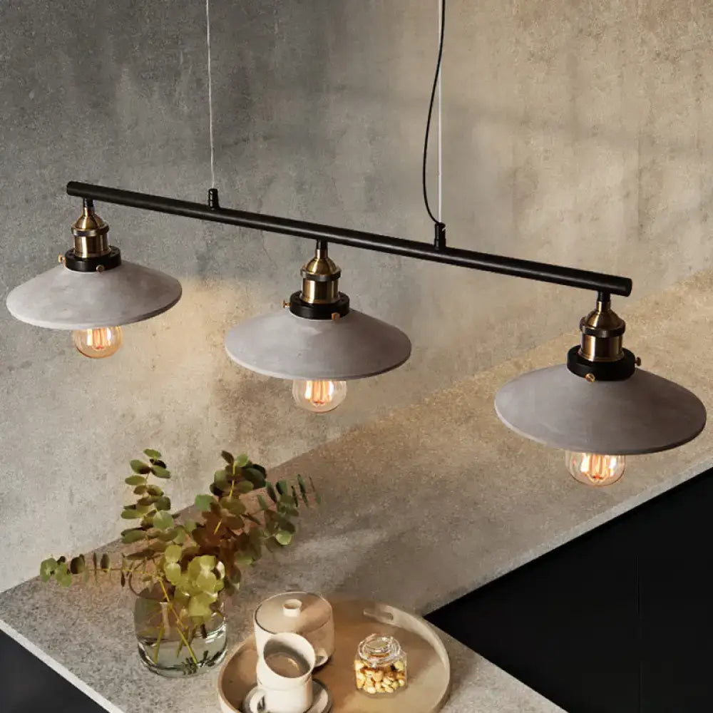 DecorBites vintage island hanging light with three matte gray cement pendant shades and brass-finished fixtures