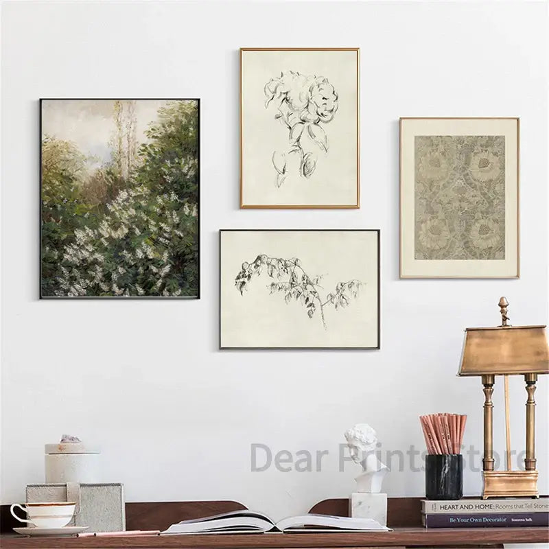 Four framed art prints featuring a vintage landscape canvas print and black and white botanical sketches for wall art