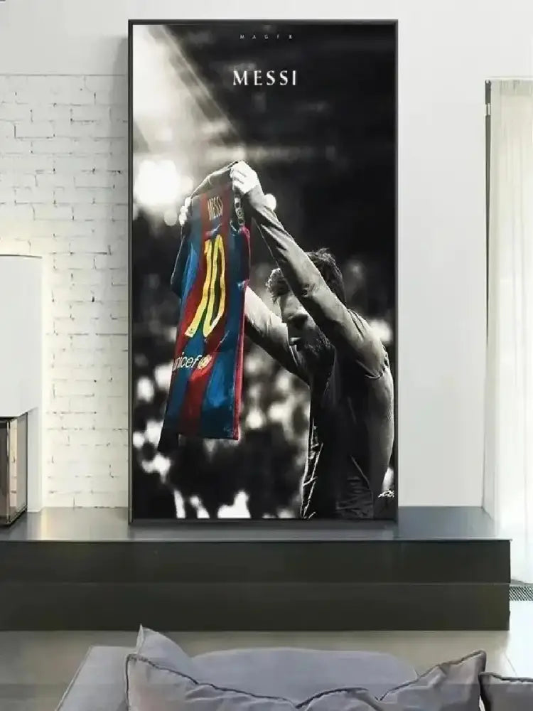 A framed black-and-white vintage Lionel Messi canvas print featuring a player holding a blue and red number 10 jersey
