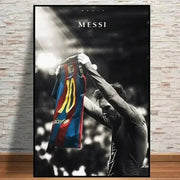 A framed vintage lionel messi canvas print featuring a black and white poster of him holding a blue and red jersey number 10