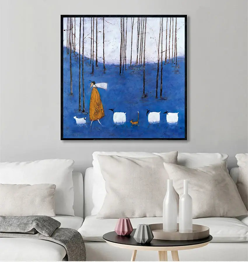 Blue-framed wall art featuring vintage nordic abstract landscape with a stylized figure in orange robe walking sheep