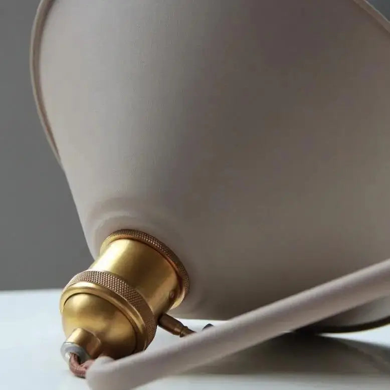 Cream-colored matte-finished lampshade with brass screw base on decorbites™ vintage plated wall lamp