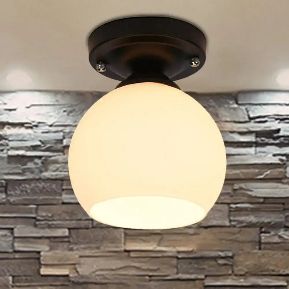 A decorbites vintage style semi flush ceiling light with a warm frosted glass shade and black bronze finish