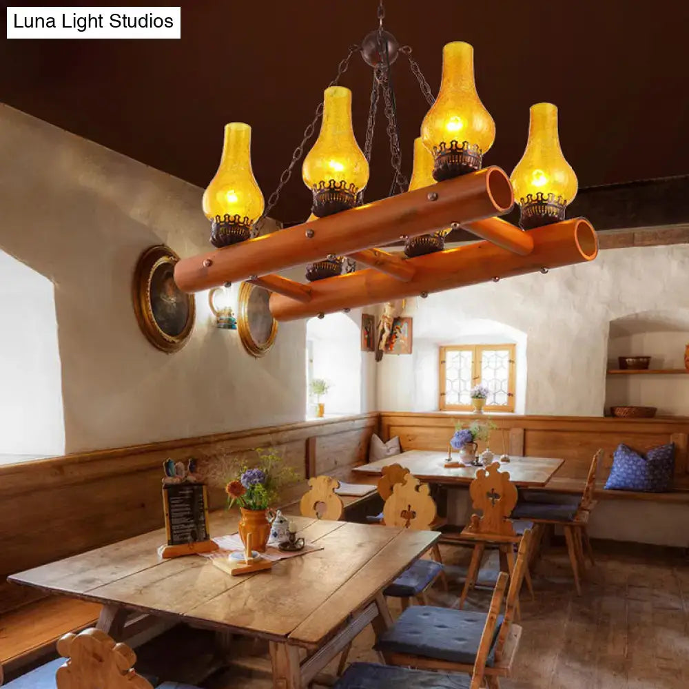 Warm amber yellow crackle glass pendant light with bamboo ladder design hanging from rustic wooden frame