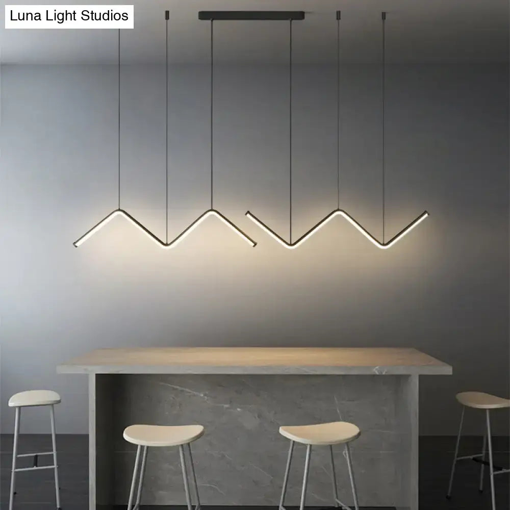 Modern black metal decorbites w-shaped pendant light fixture with zigzag design above minimalist dining bar