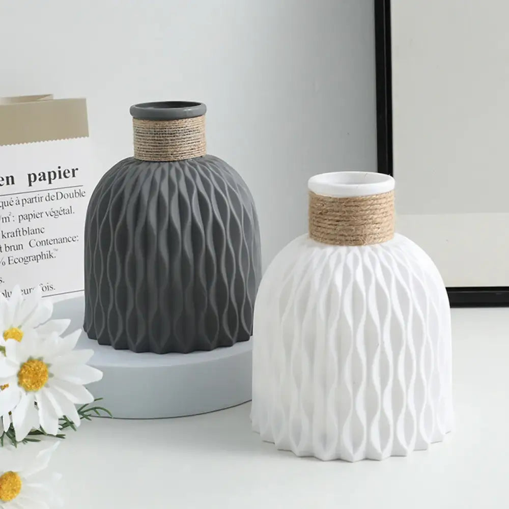 Two DecorBites™ water ripple plastic vases in matte gray and white with twine bands in modern Nordic style