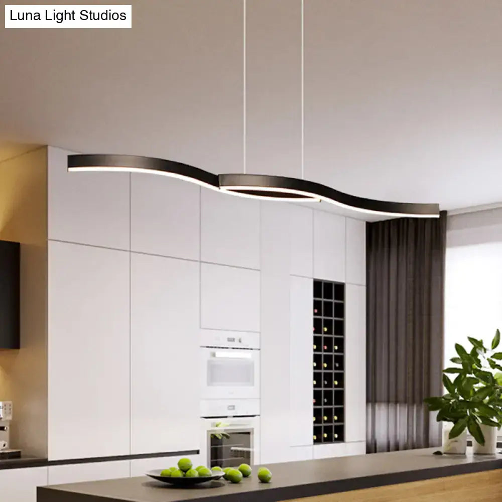 Modern black curved waves island lamp with sleek aluminum finish hanging above kitchen island for dining room lighting