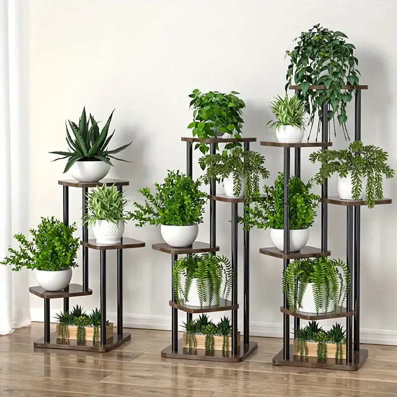 Set of three tiered DecorBites™ wooden flower plant stands with dark brown shelves and black metal frames holding green plants