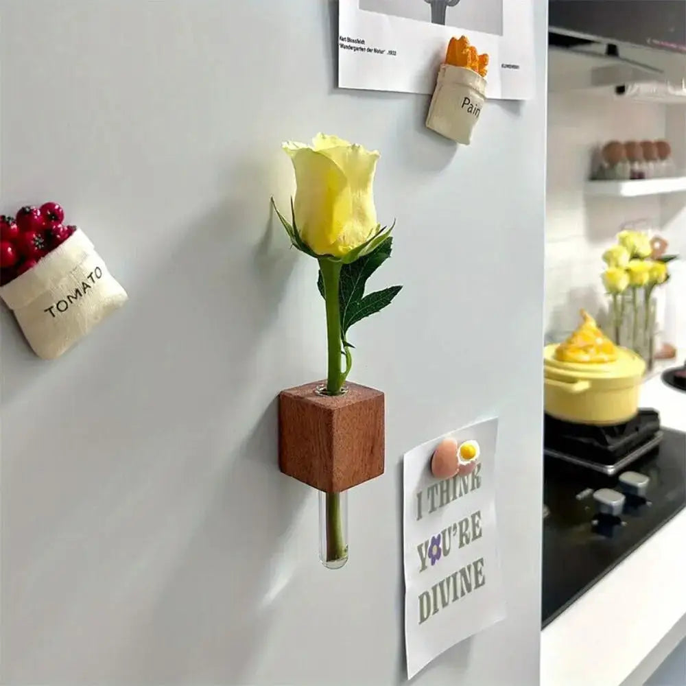 DecorBites wooden cube-shaped magnetic test tube vase holding a single yellow rose with green stem and leaves