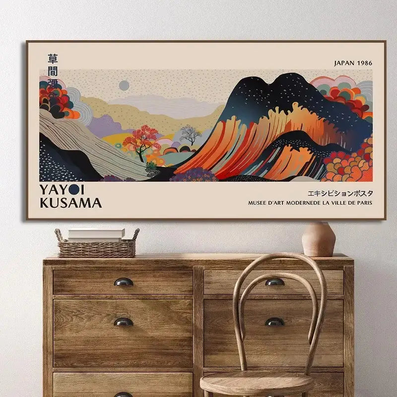 A framed vintage-style yayoi kusama flower art poster featuring a stylized mountain landscape in orange and blue hues