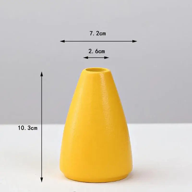 A sleek matte yellow porcelain flower vase by DecorBites with a tapered conical shape for home decor