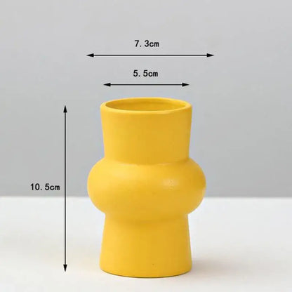 A vibrant yellow porcelain flower vase by DecorBites with a modern sculpted design for elegant home decor