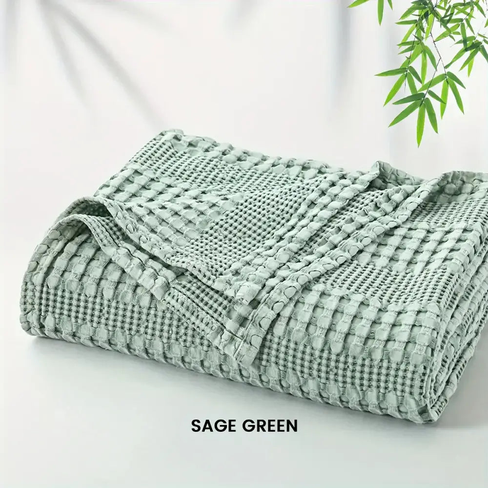 Sage green cotton waffle blanket made from decorbites bamboo cotton waffle weave for lightweight bedroom use