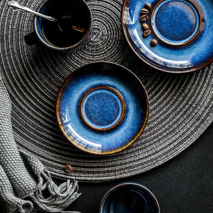 Deep blue glossy ceramic coffee cup saucer with brown rim, part of an espresso coffee cup saucer set for dining room