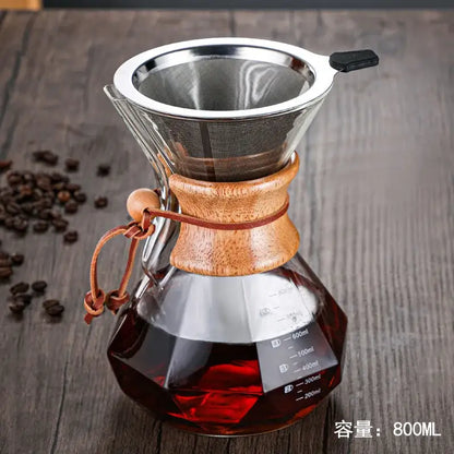 A sleek diamond glass hand brew coffee maker with wooden collar stainless steel filter and leather strap for kitchen use