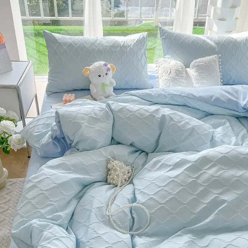 Light blue quilted duvet cover with subtle diamond jacquard pattern for skin friendly bedroom bedding